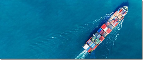 Aerial view of cargo ship with contrail in the ocean sea ship carrying container and running from container international port smart freight shipping by ship service